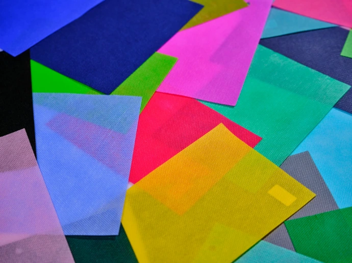 a pile of multicolored papers sitting on top of each other