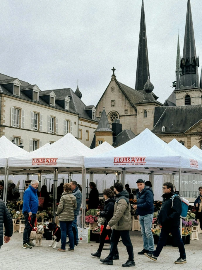 A group of people standing around tents in front of a church